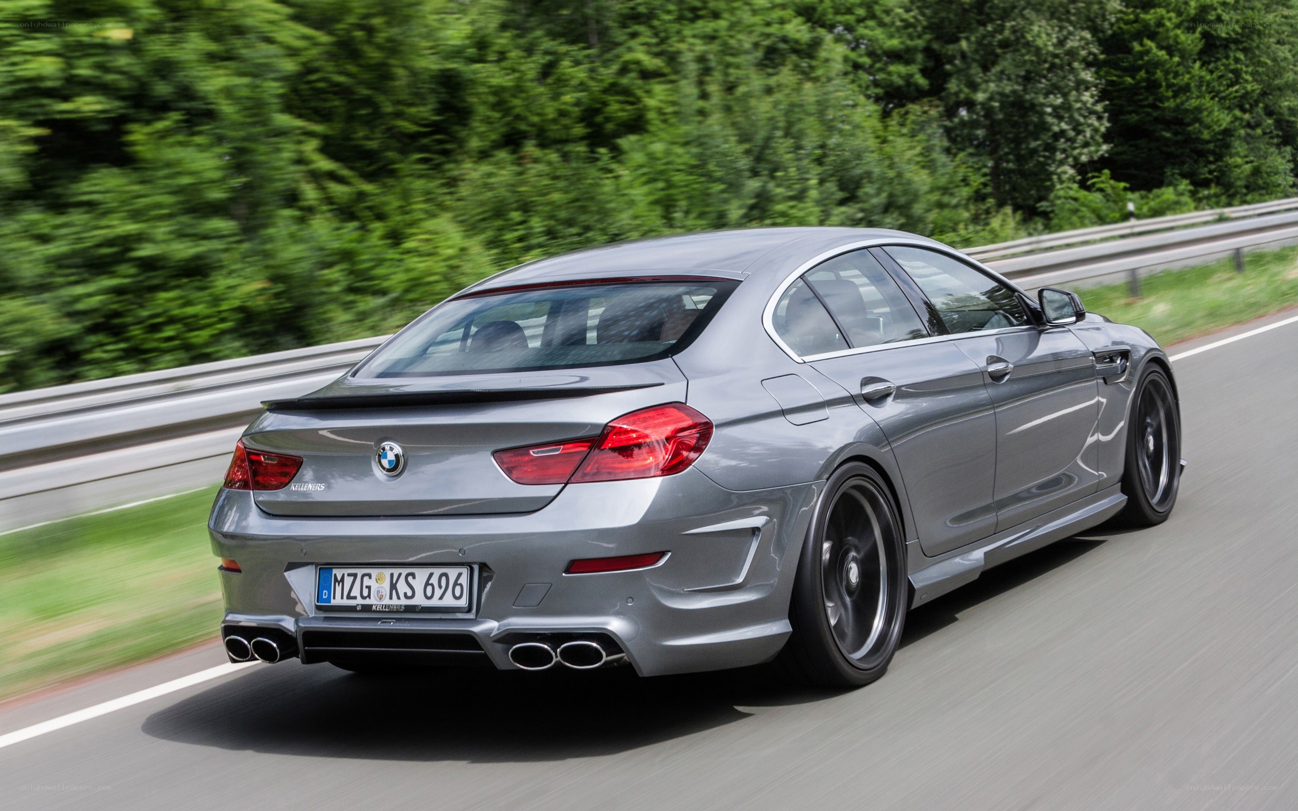 silver bmw m6 driving on road