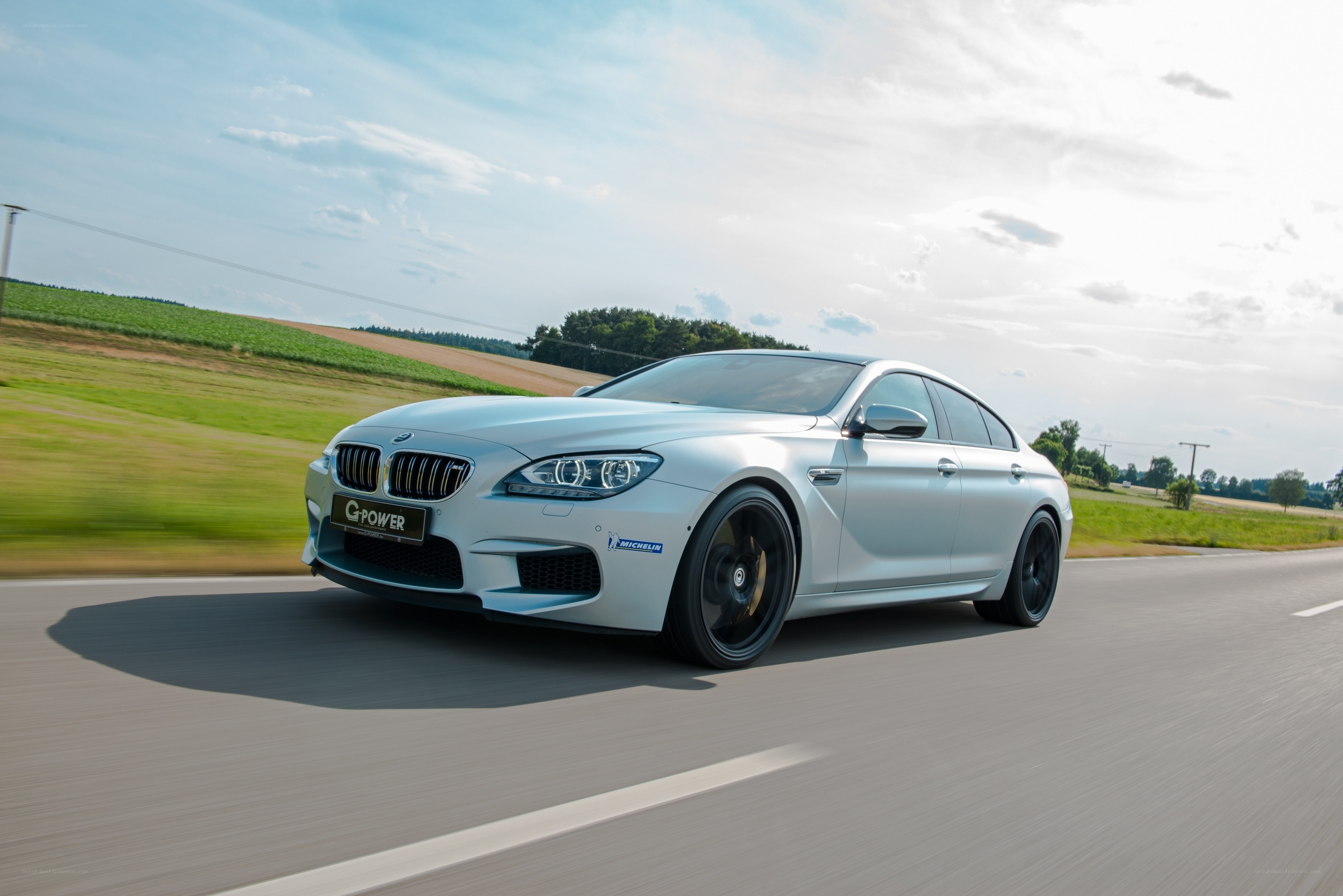 silver bmw m6 driving on road
