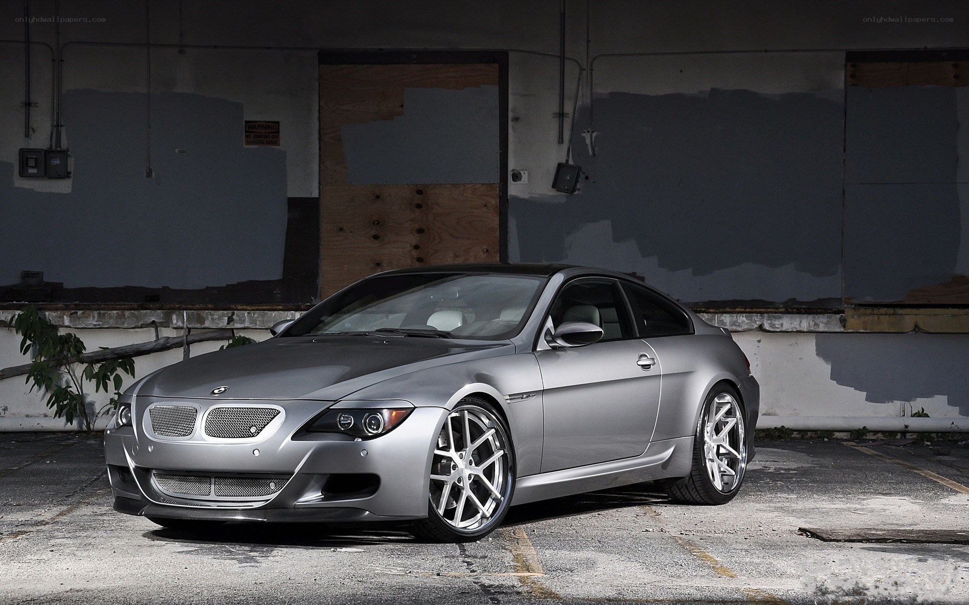Silver BMW M6 in an industrial setting