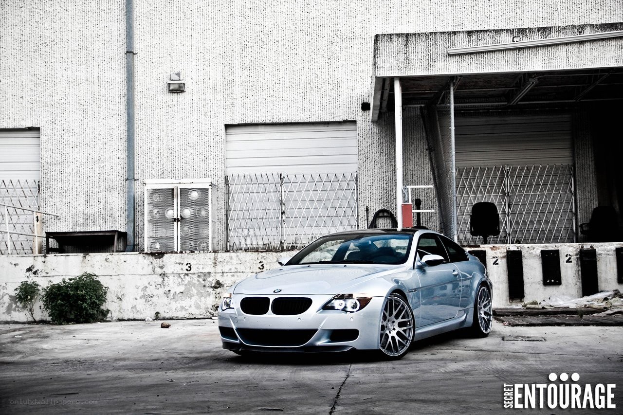 silver bmw m6 in industrial setting
