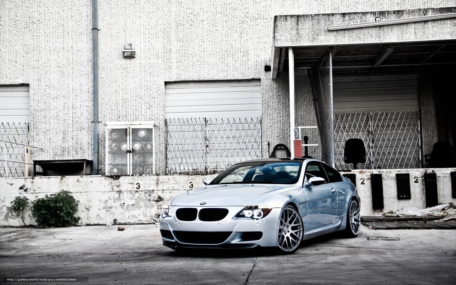 Silver BMW M6 in industrial setting