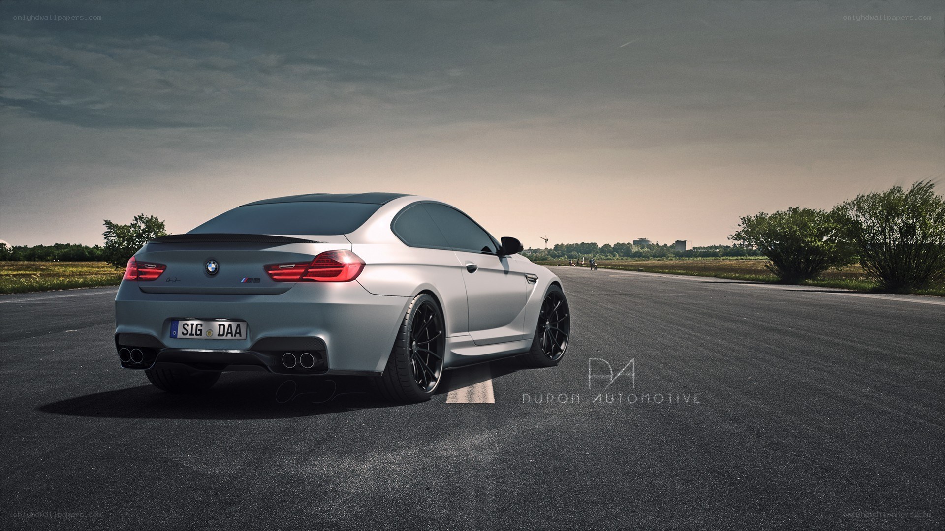 silver bmw m6 on a road