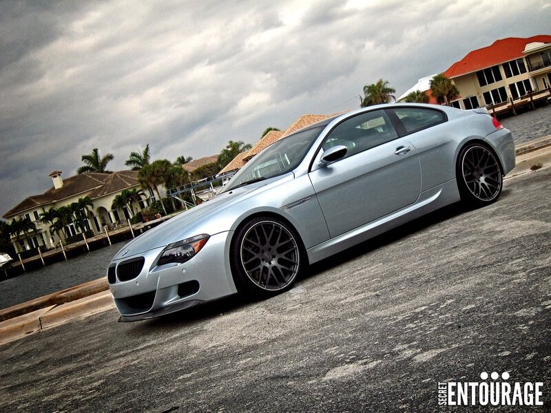 silver bmw m6 on a waterfront street