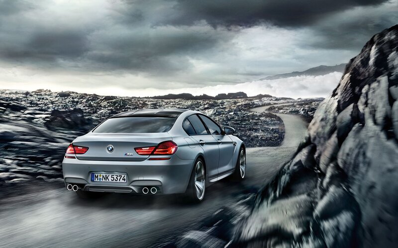 silver bmw m6 on a winding road