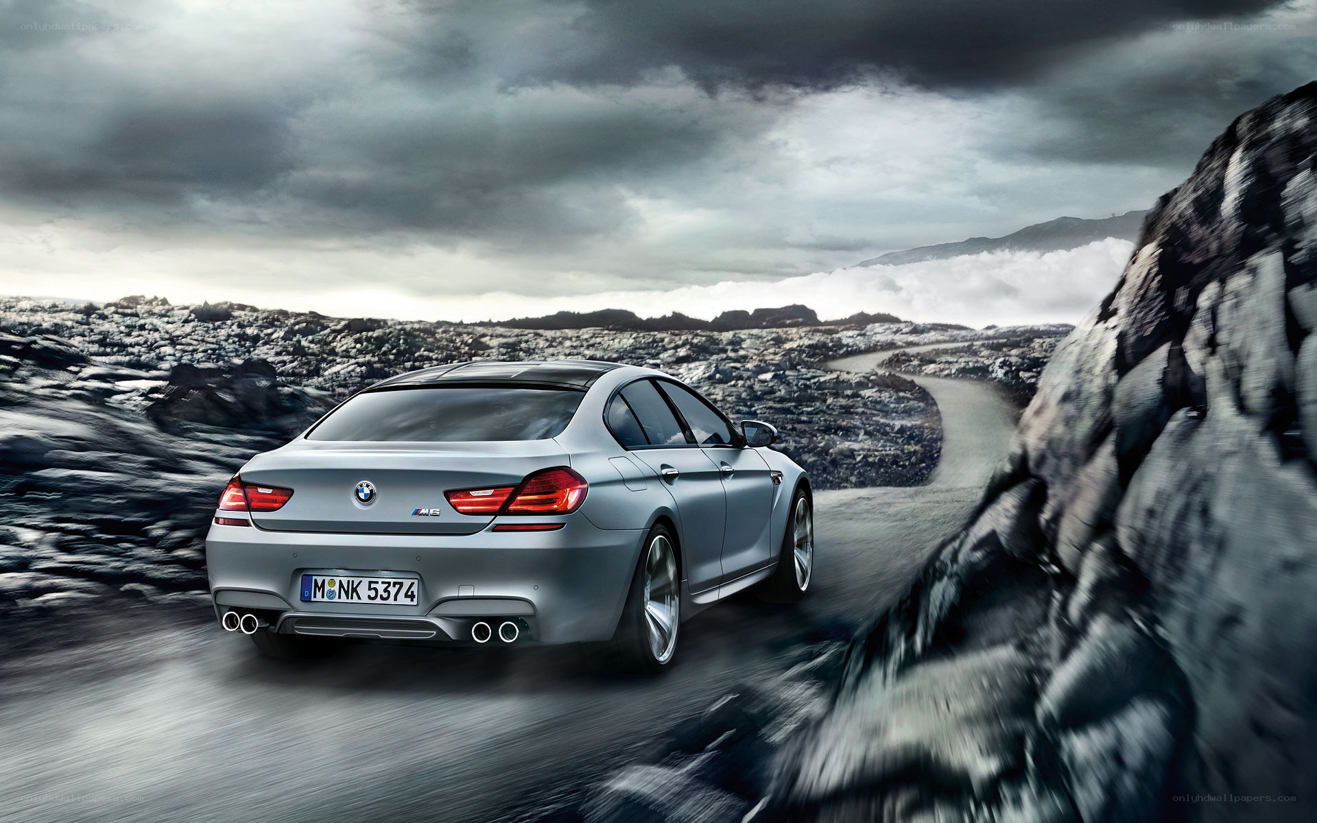 silver bmw m6 on a winding road