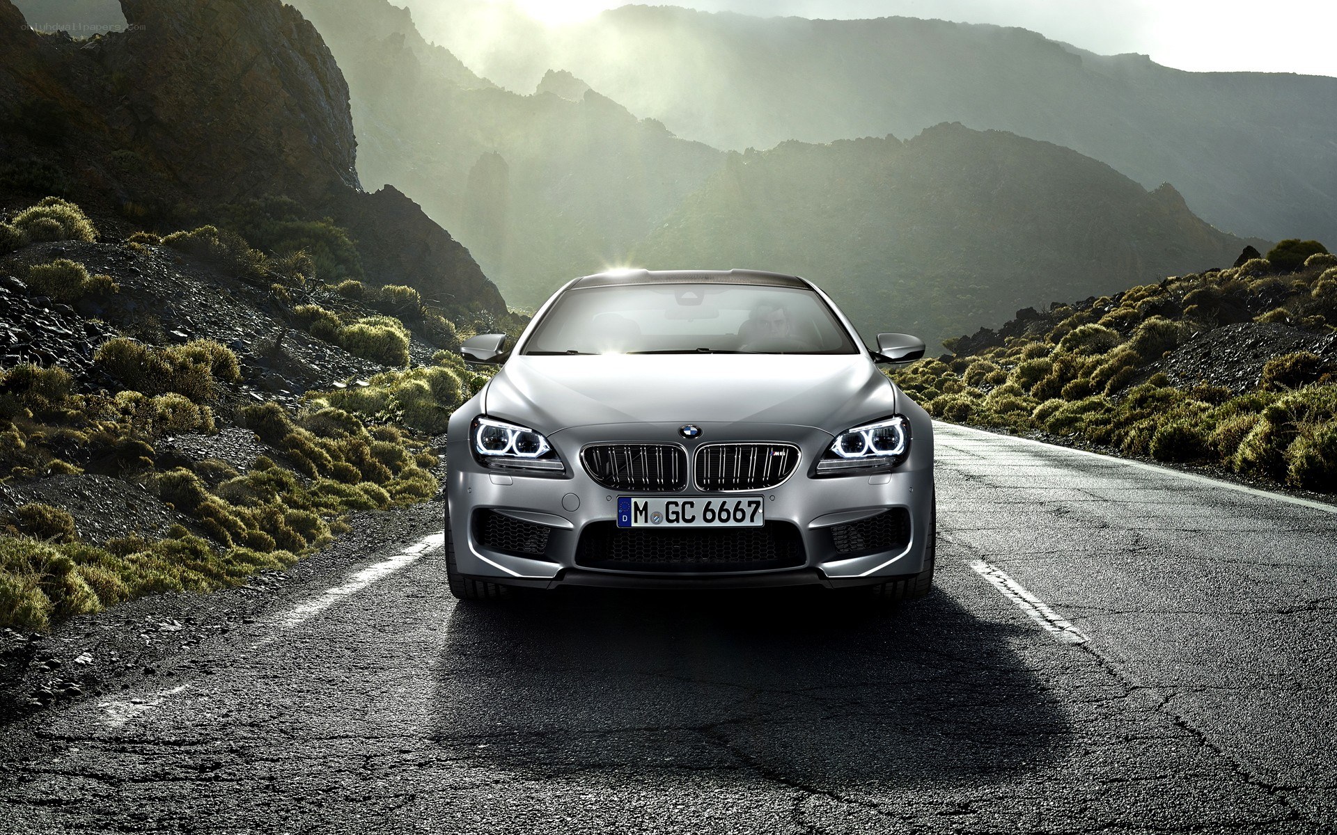 Silver BMW M6 on mountain road