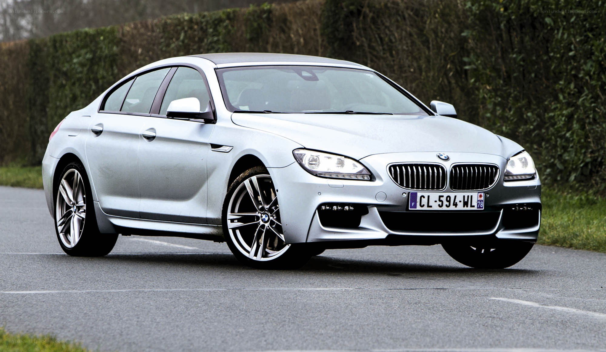 silver bmw m6 on road
