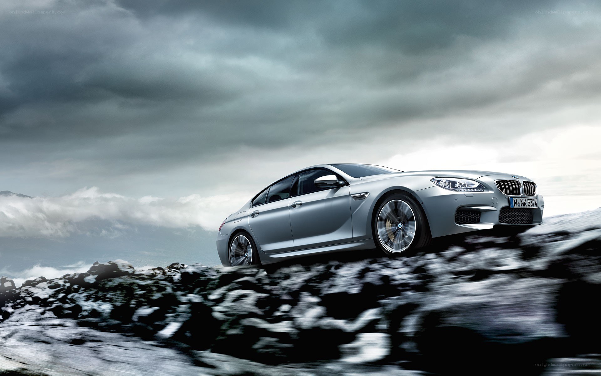 Silver BMW M6 on rocky terrain