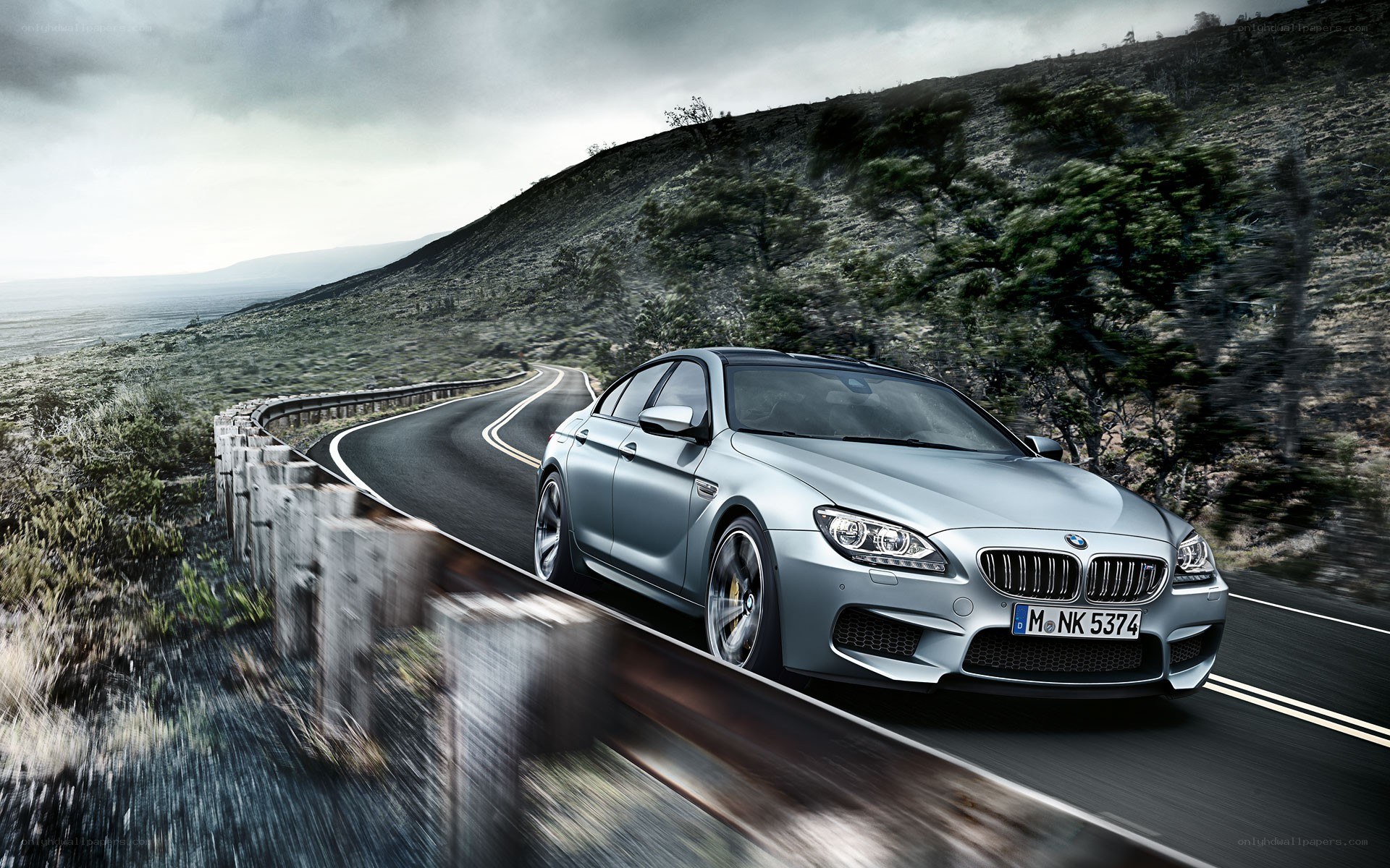 Silver BMW M6 on winding road