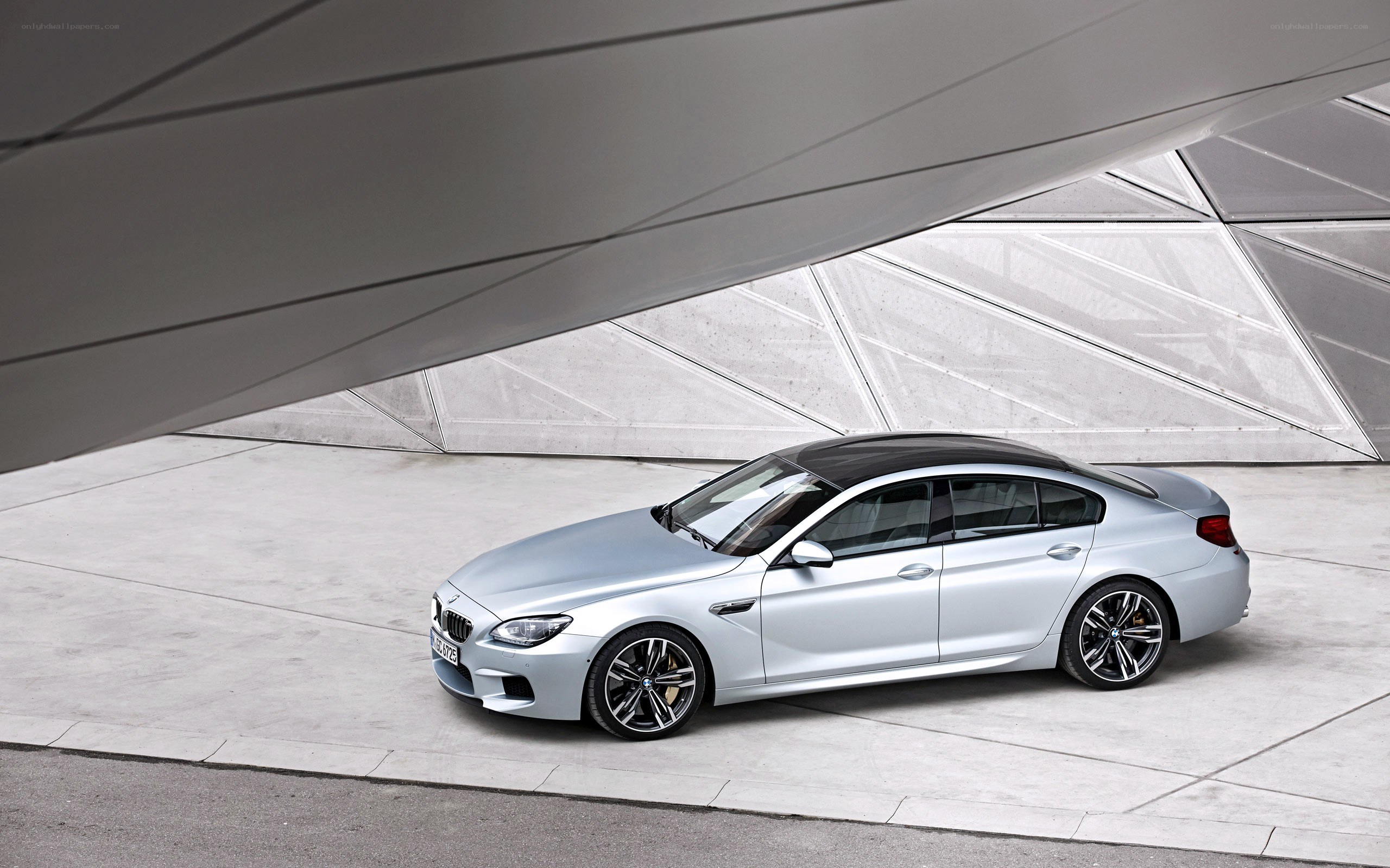 Silver BMW M6 parked under structure