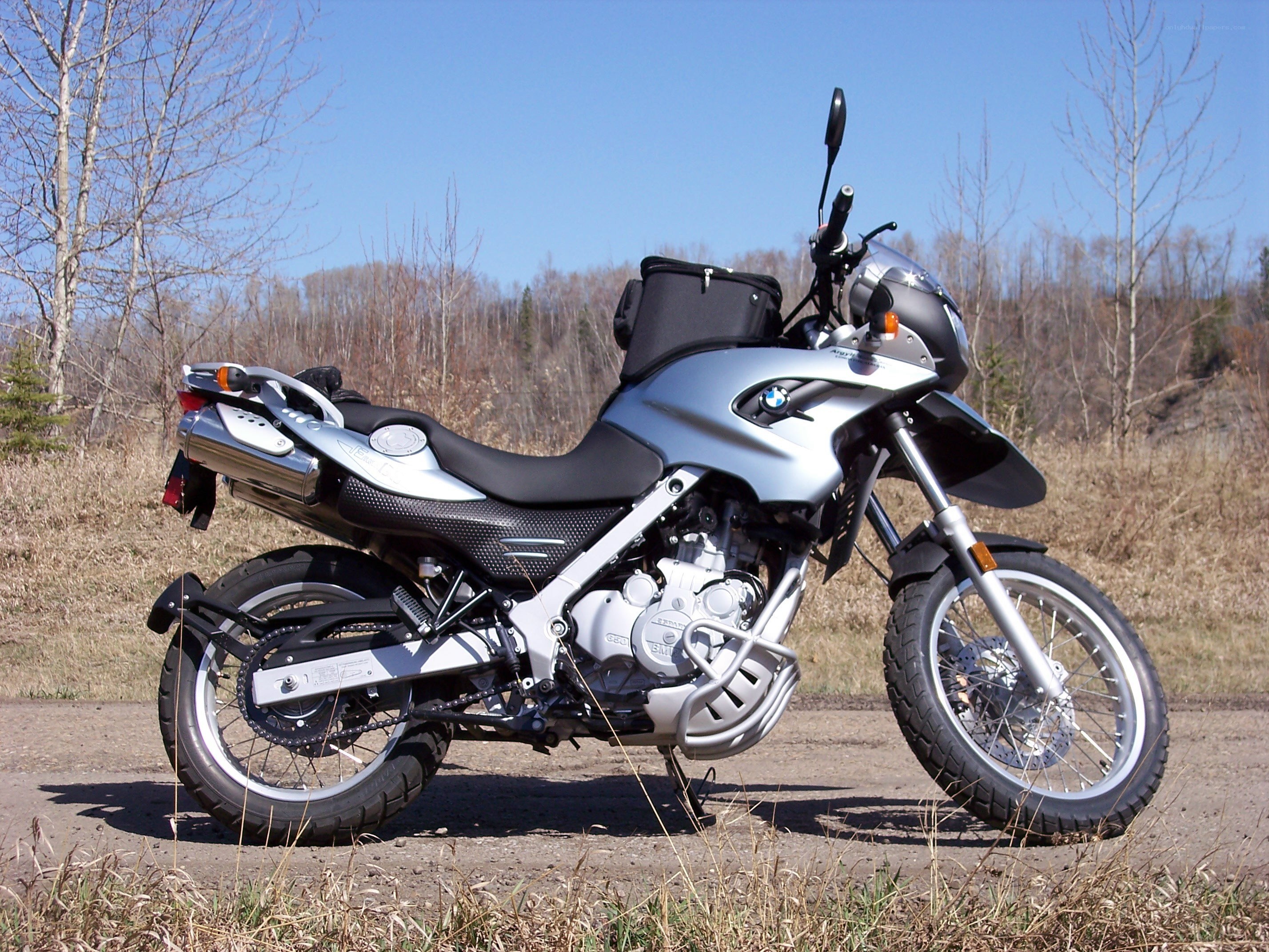 Silver BMW motorcycle on dirt path