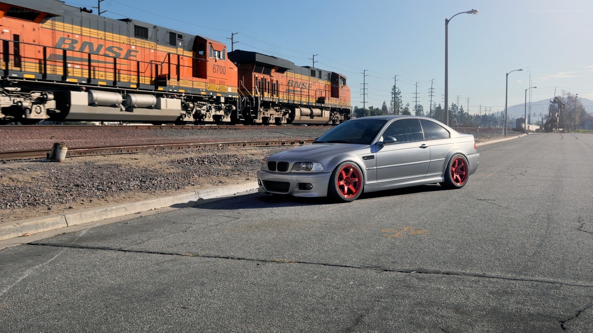 Silver BMW near train tracks