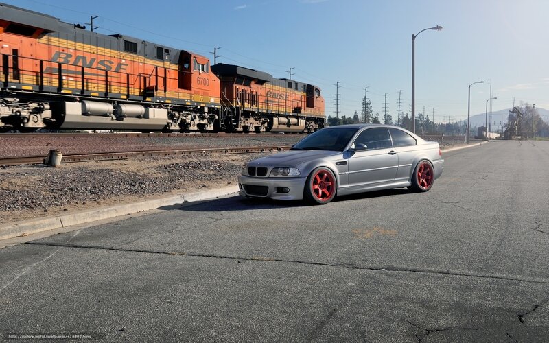Silver BMW near train tracks
