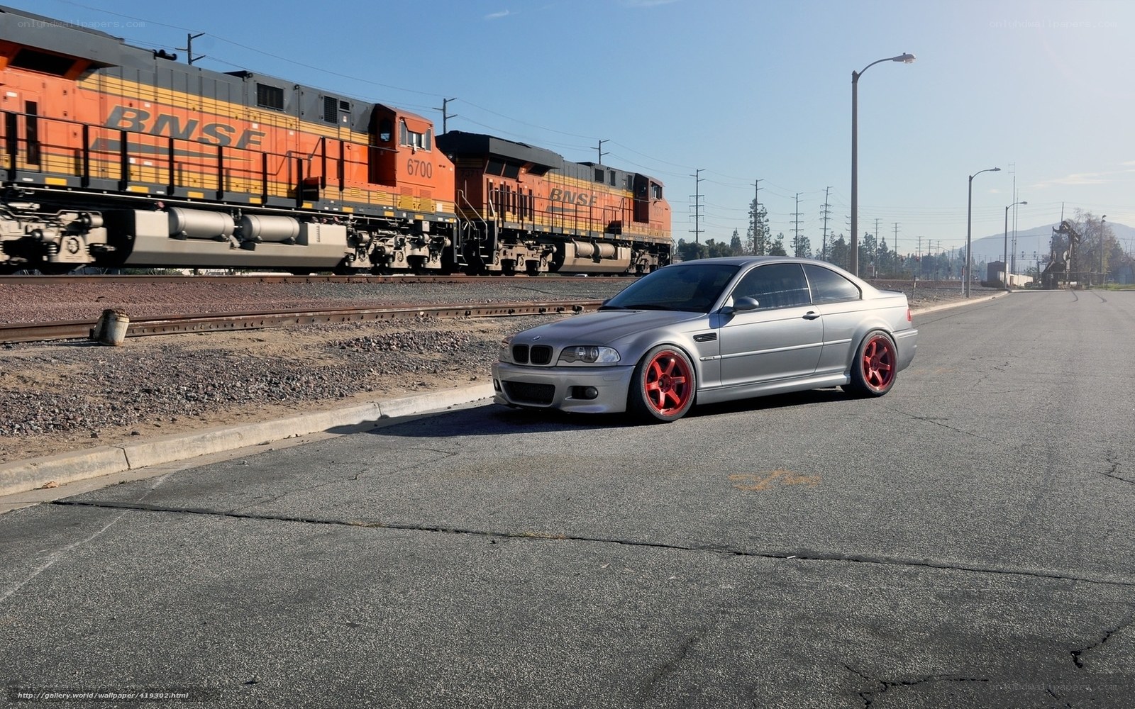 Silver BMW near train tracks