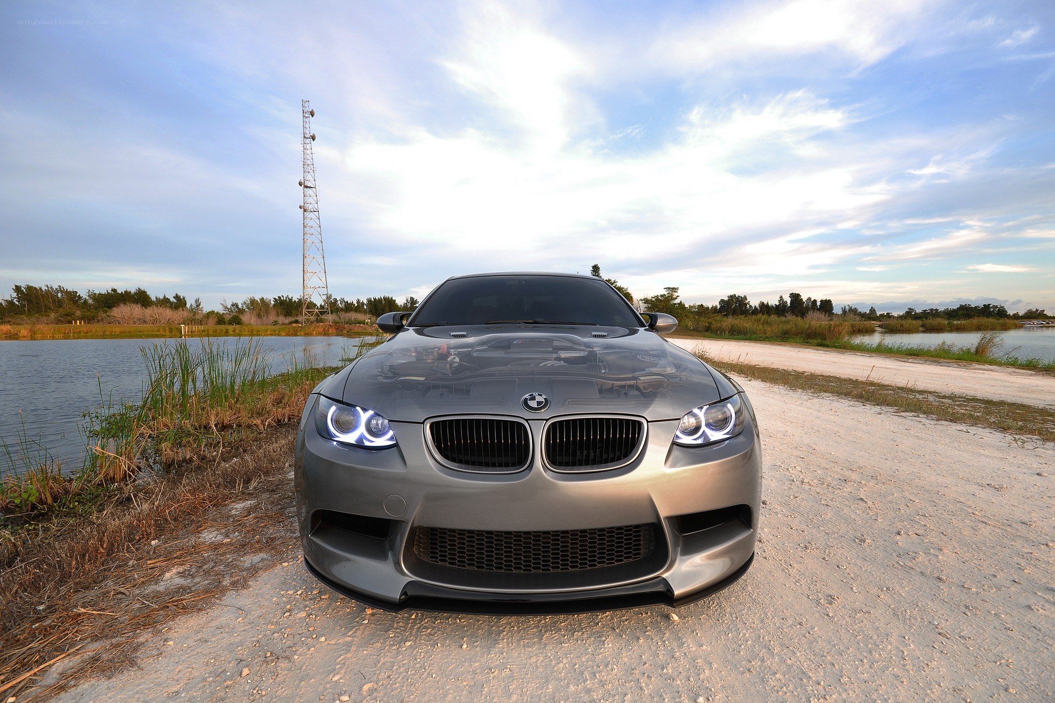 silver BMW on a dirt road