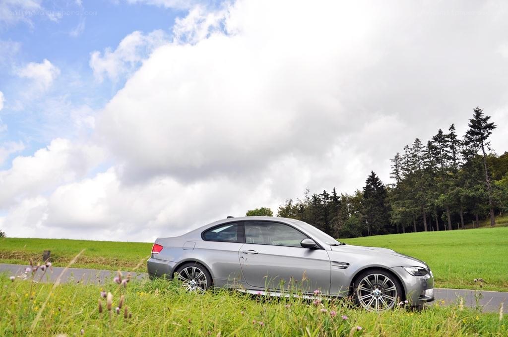 Silver BMW on a grassy hill