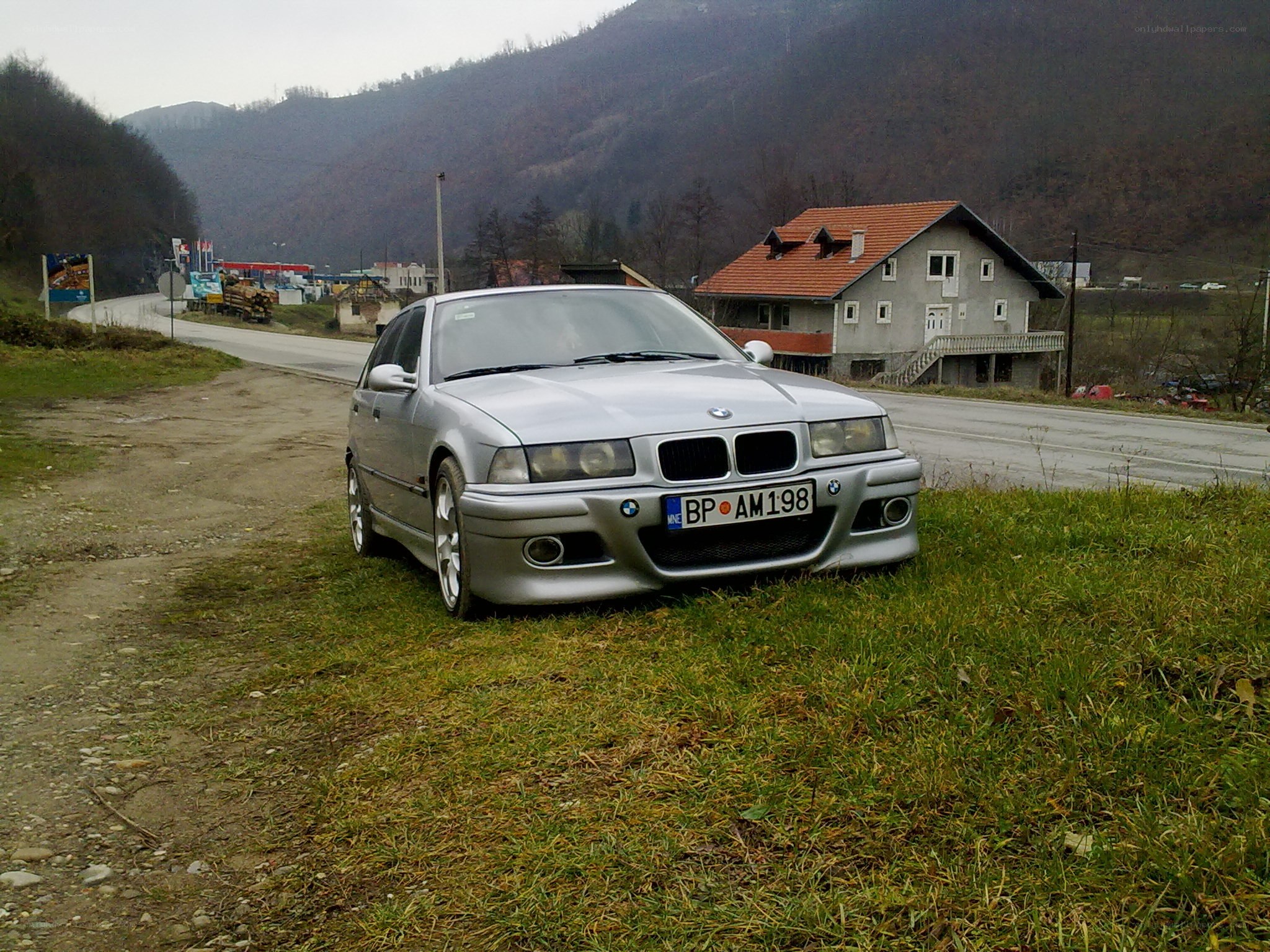Silver BMW on a grassy verge