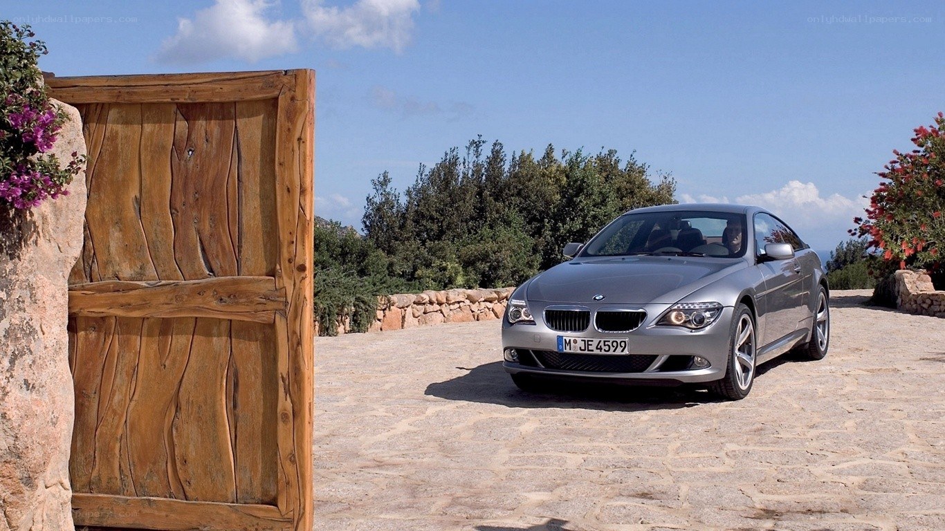 Silver BMW on a stone driveway