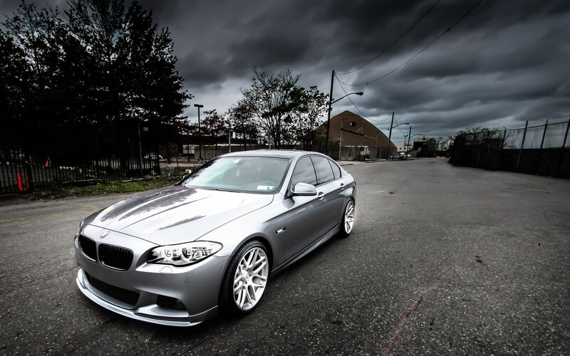 Silver BMW on a stormy street