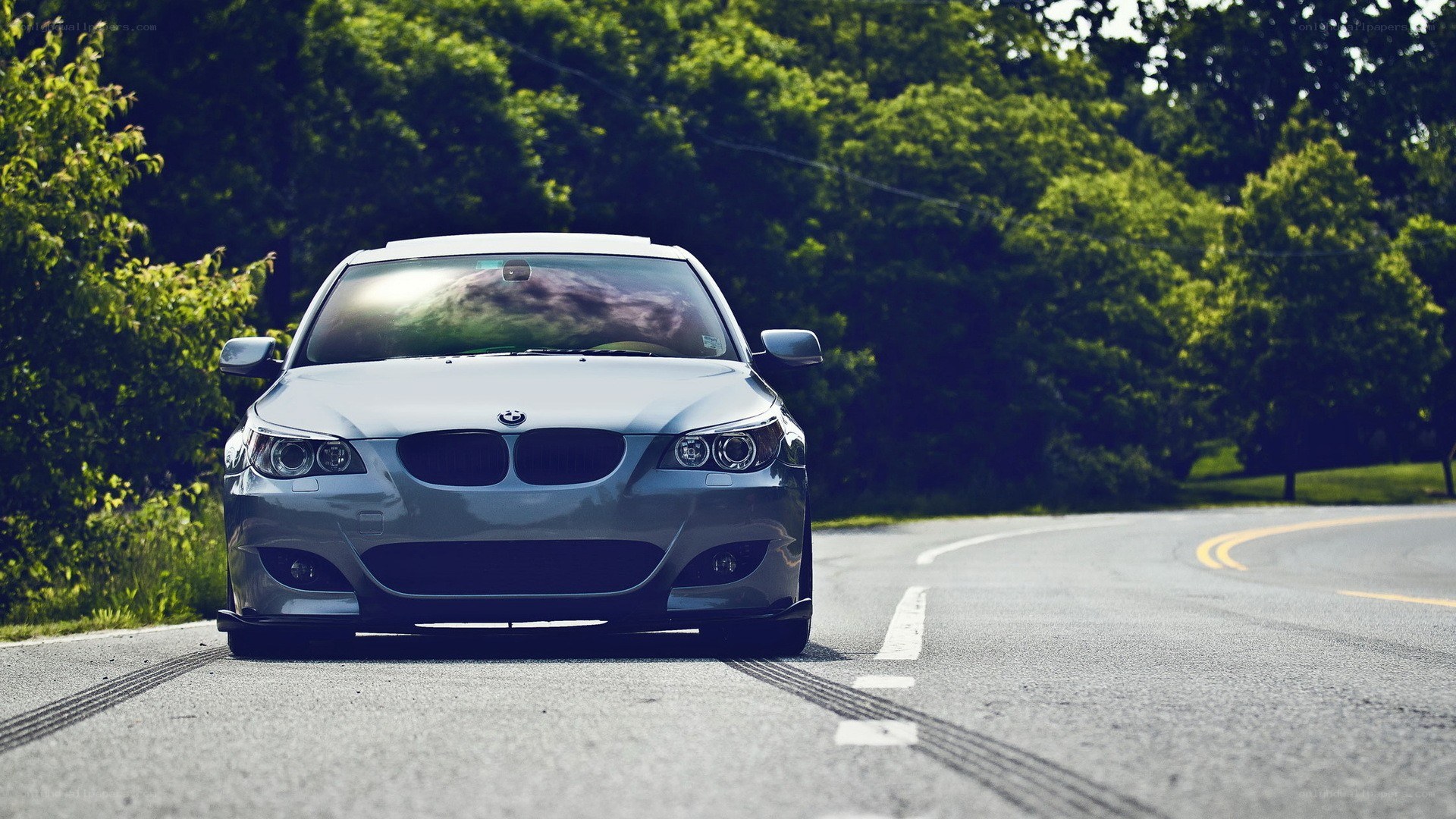 silver bmw on a winding road