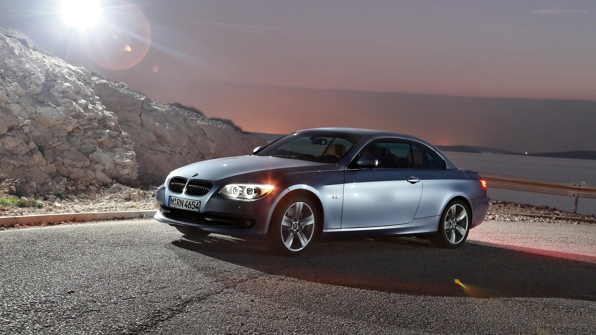 Silver BMW on coastal road