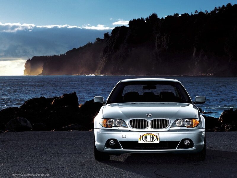 Silver BMW on coastal road