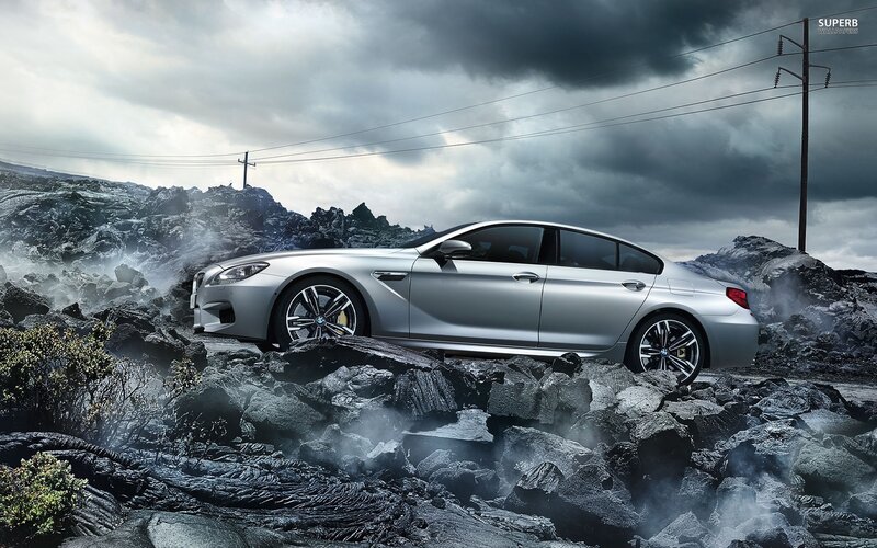 Silver BMW on volcanic rocks