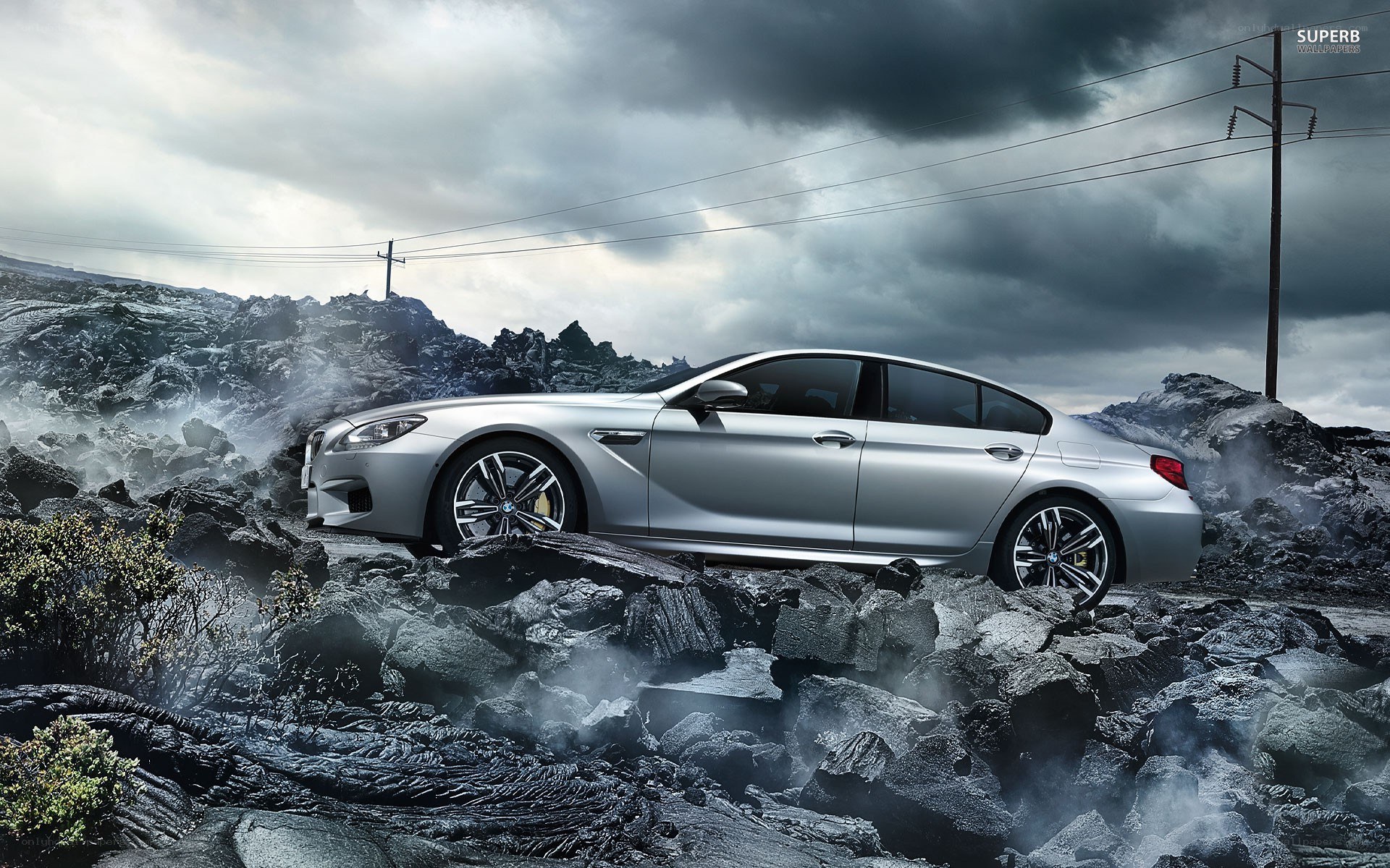 Silver BMW on volcanic rocks