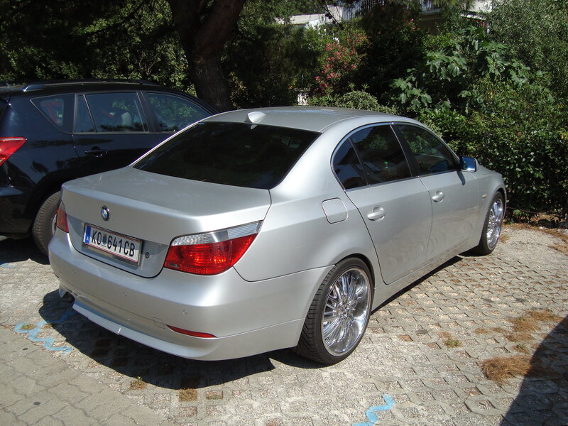 silver bmw parked on cobblestones