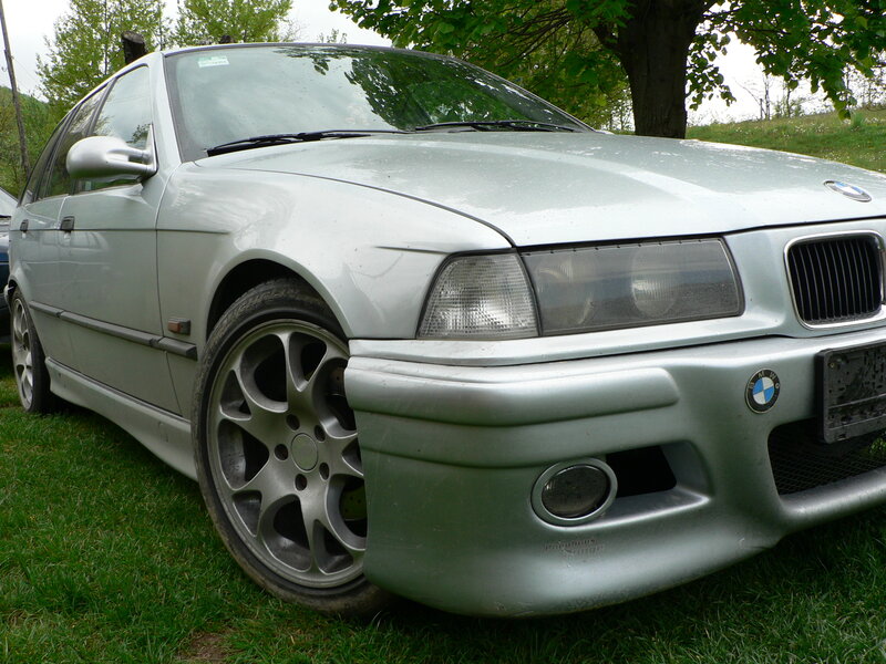 silver bmw parked on grass