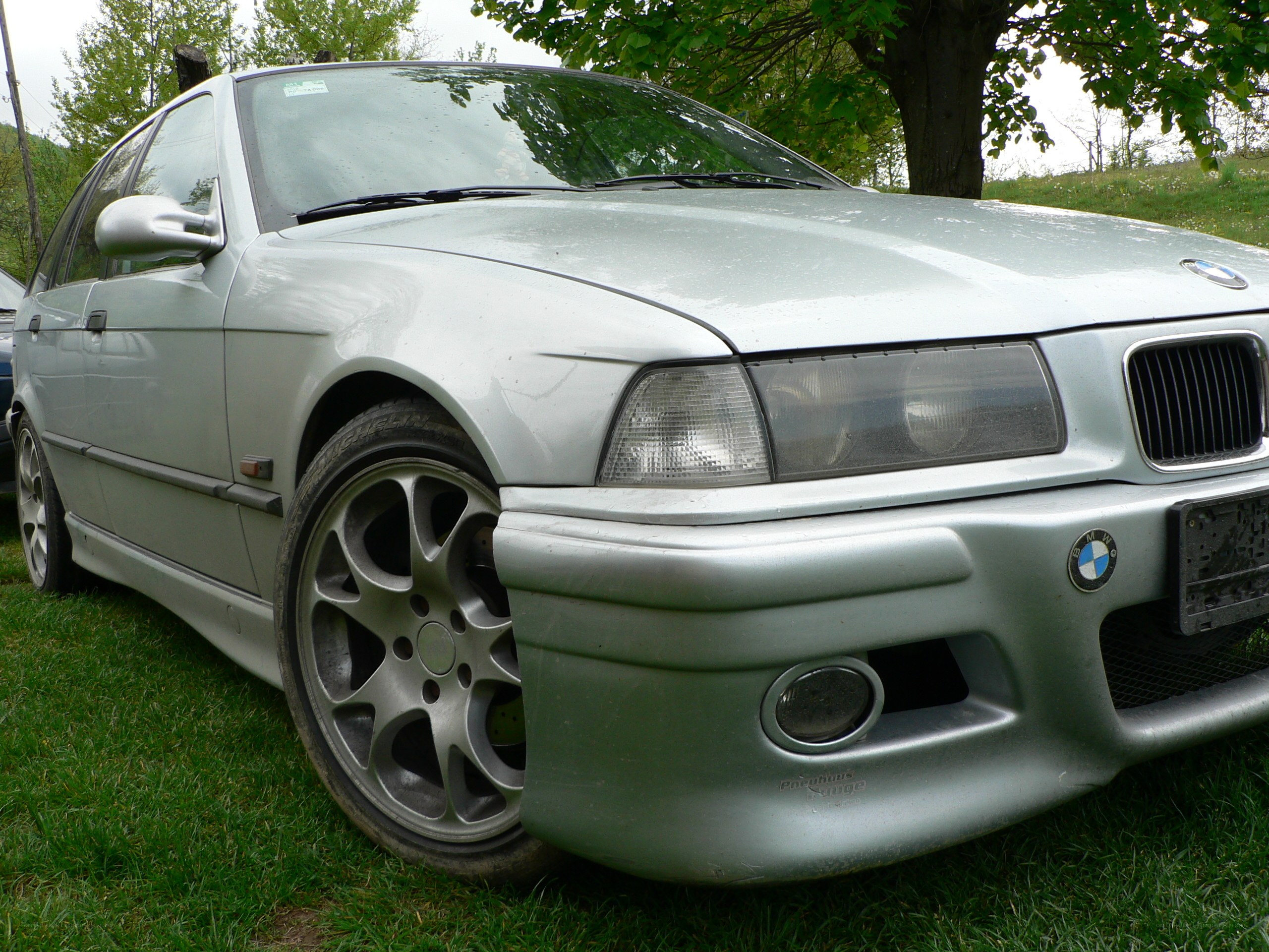 silver bmw parked on grass
