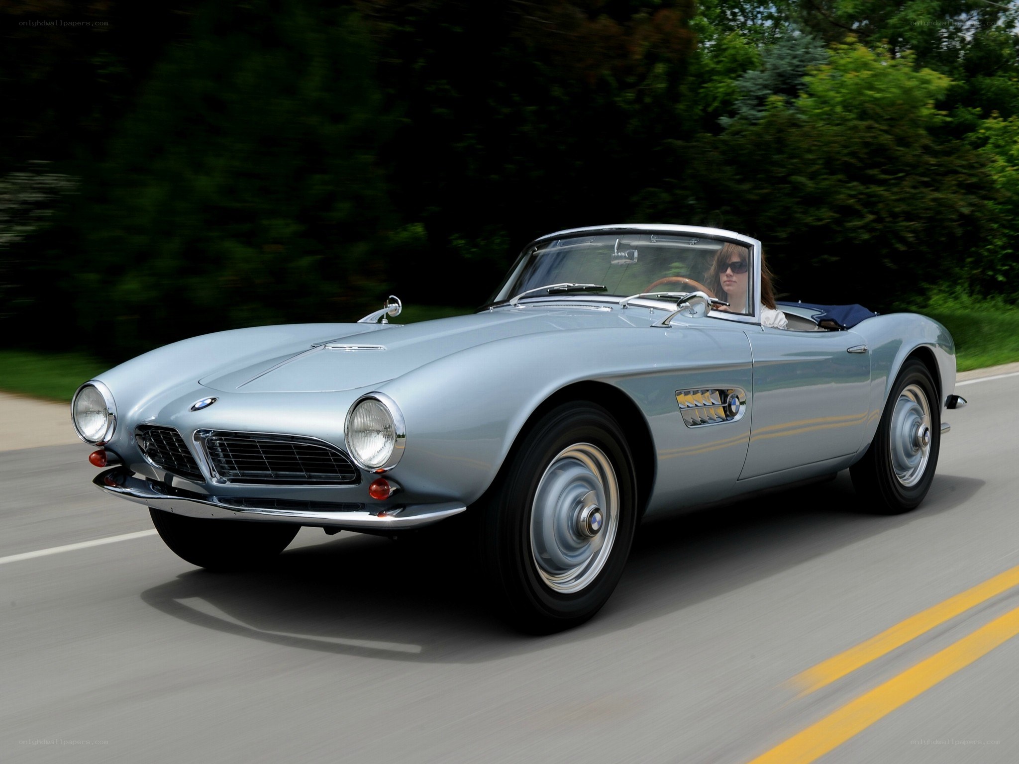 Silver BMW roadster in motion