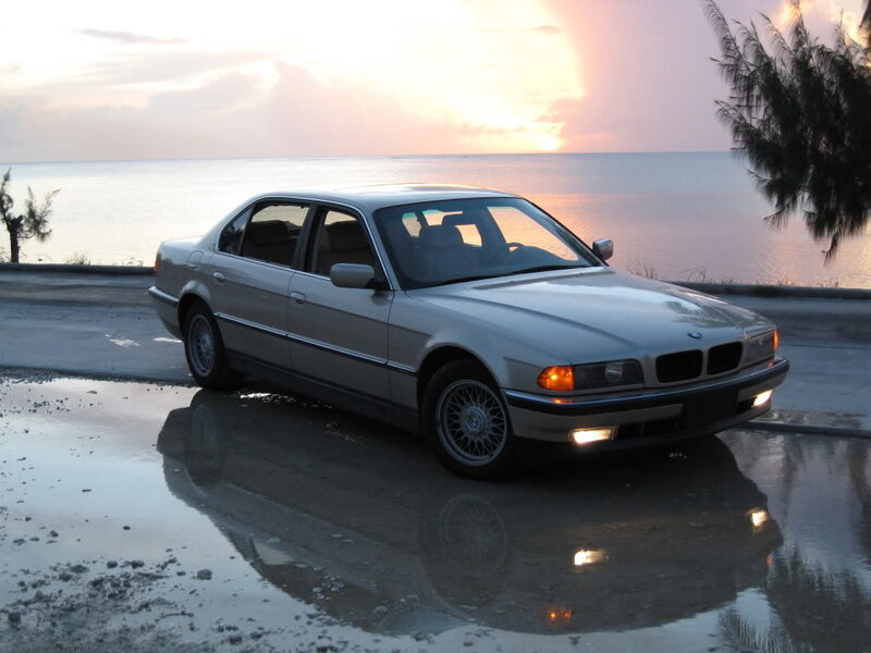 silver bmw sedan at sunset