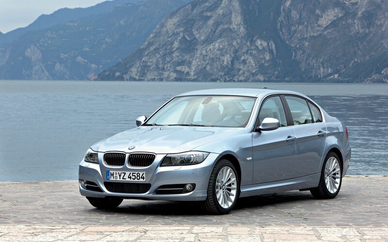 silver bmw sedan by lake