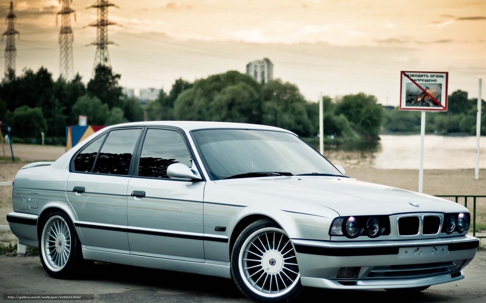 Silver BMW sedan by river