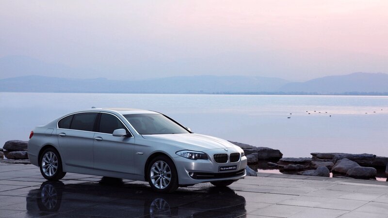 Silver BMW sedan by the lake