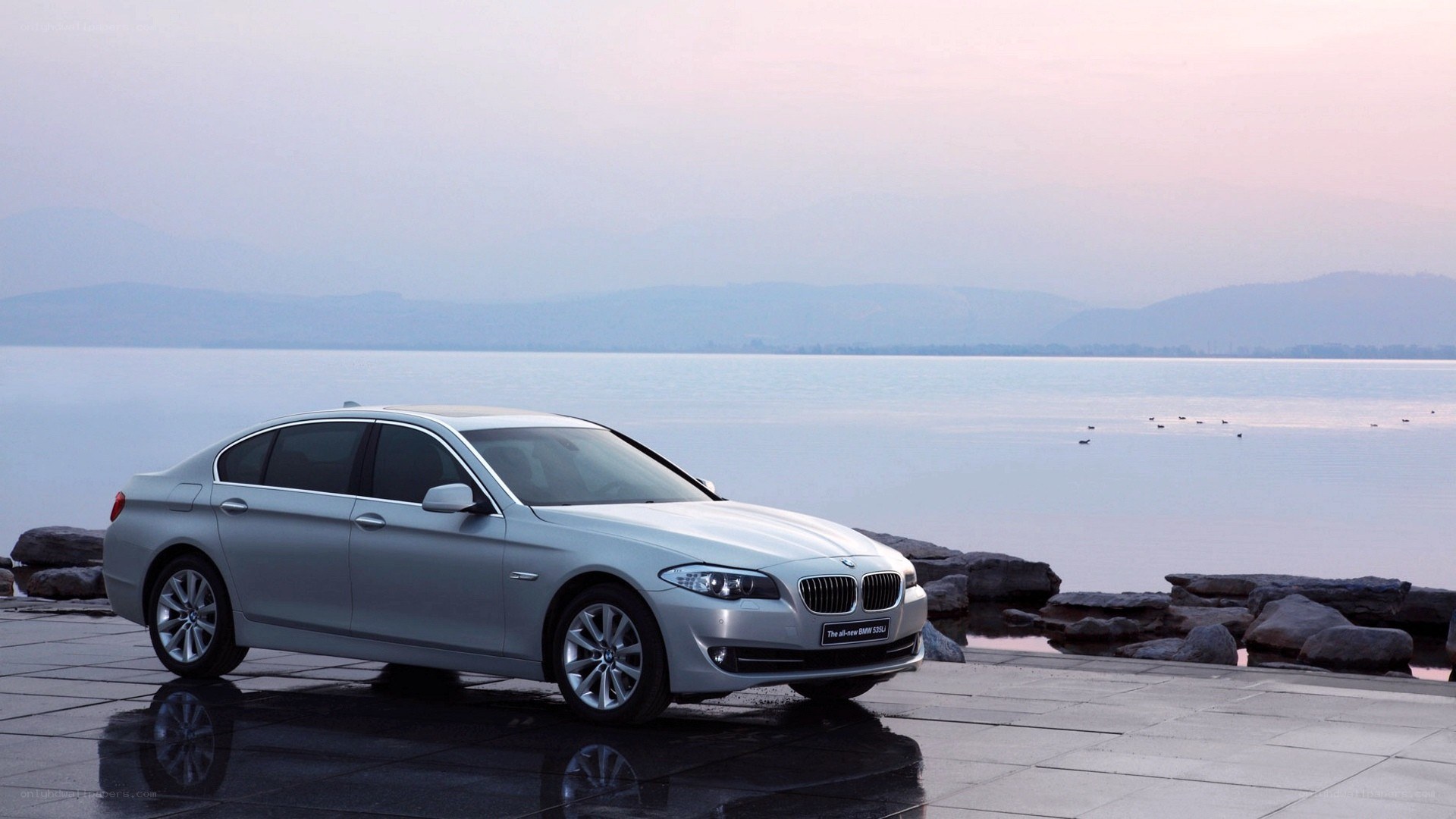Silver BMW sedan by the lake