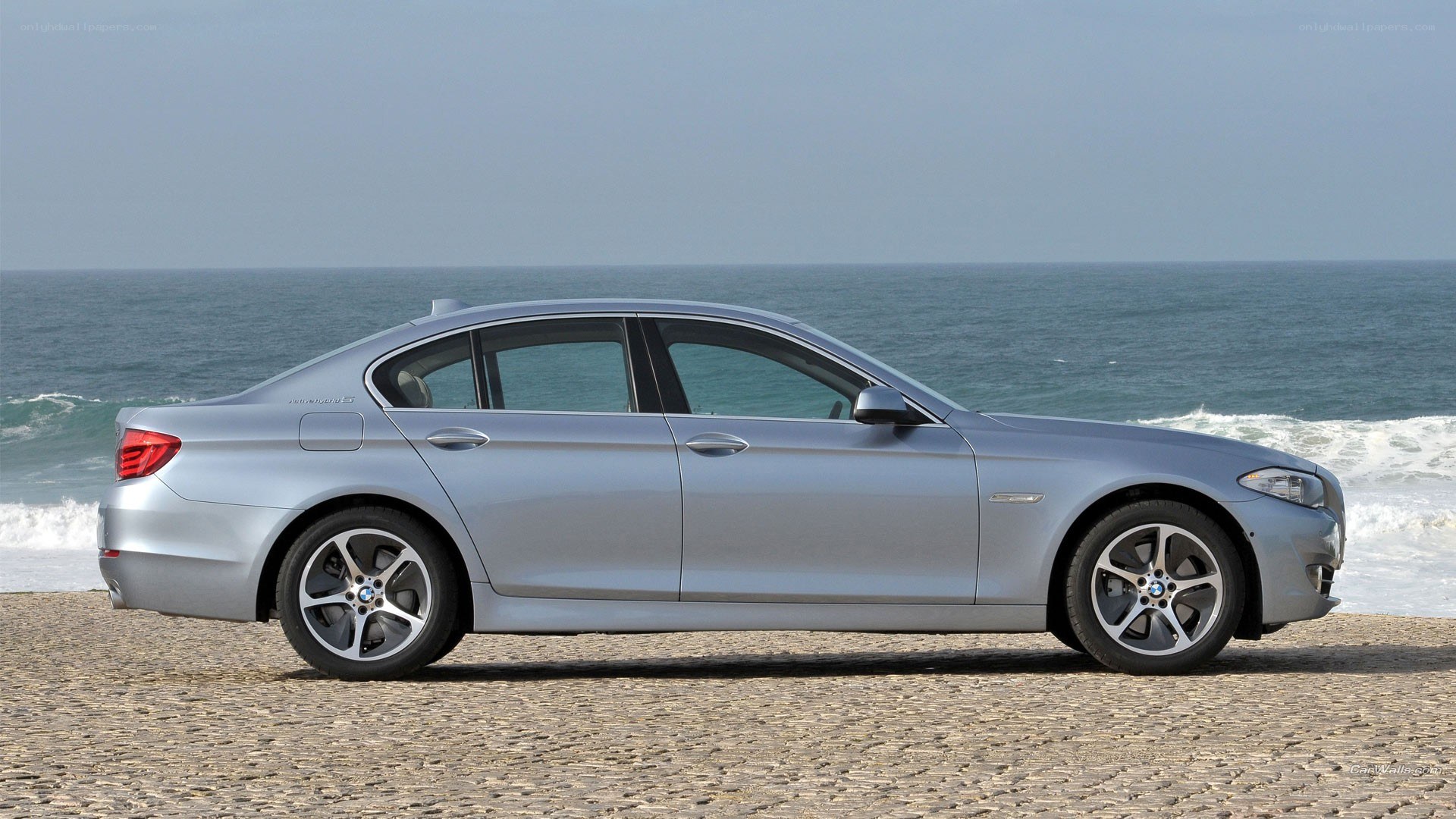 silver bmw sedan by the sea
