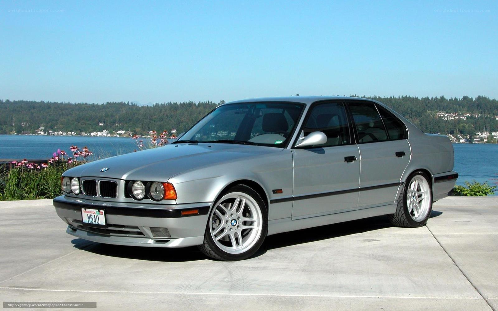 Silver BMW sedan by the water