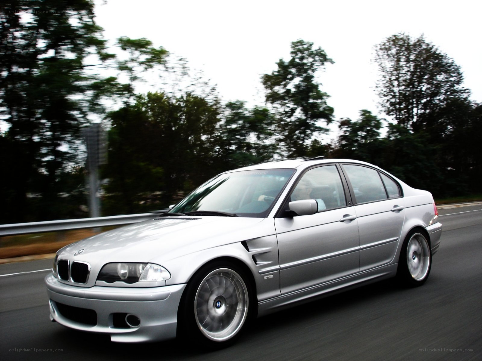 silver bmw sedan in motion
