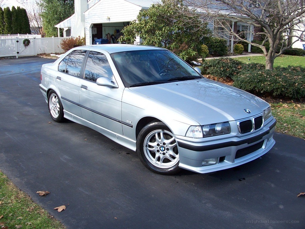 silver bmw sedan on driveway