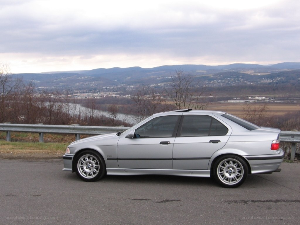 silver bmw sedan on overlook