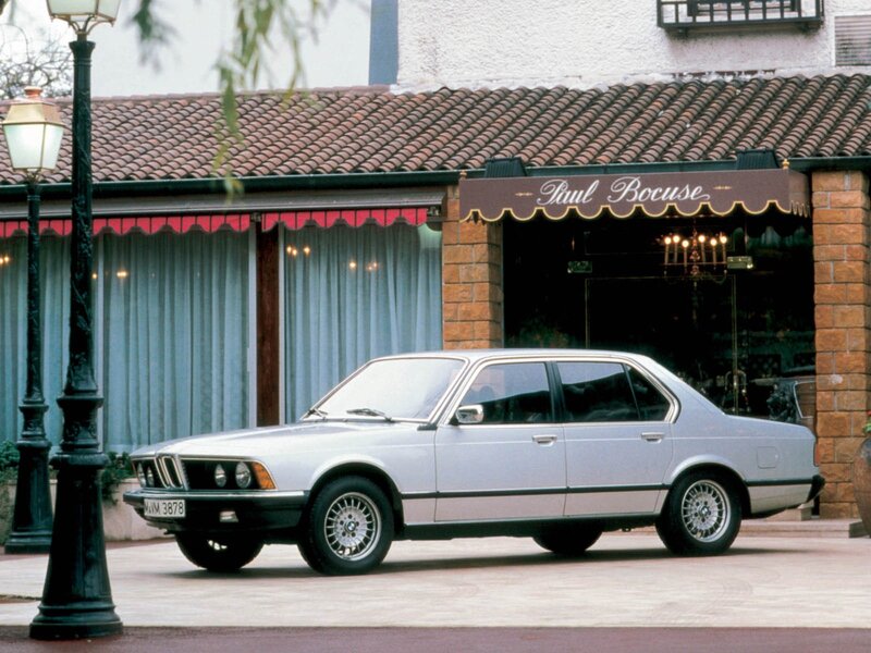 Silver BMW sedan parked outside a restaurant