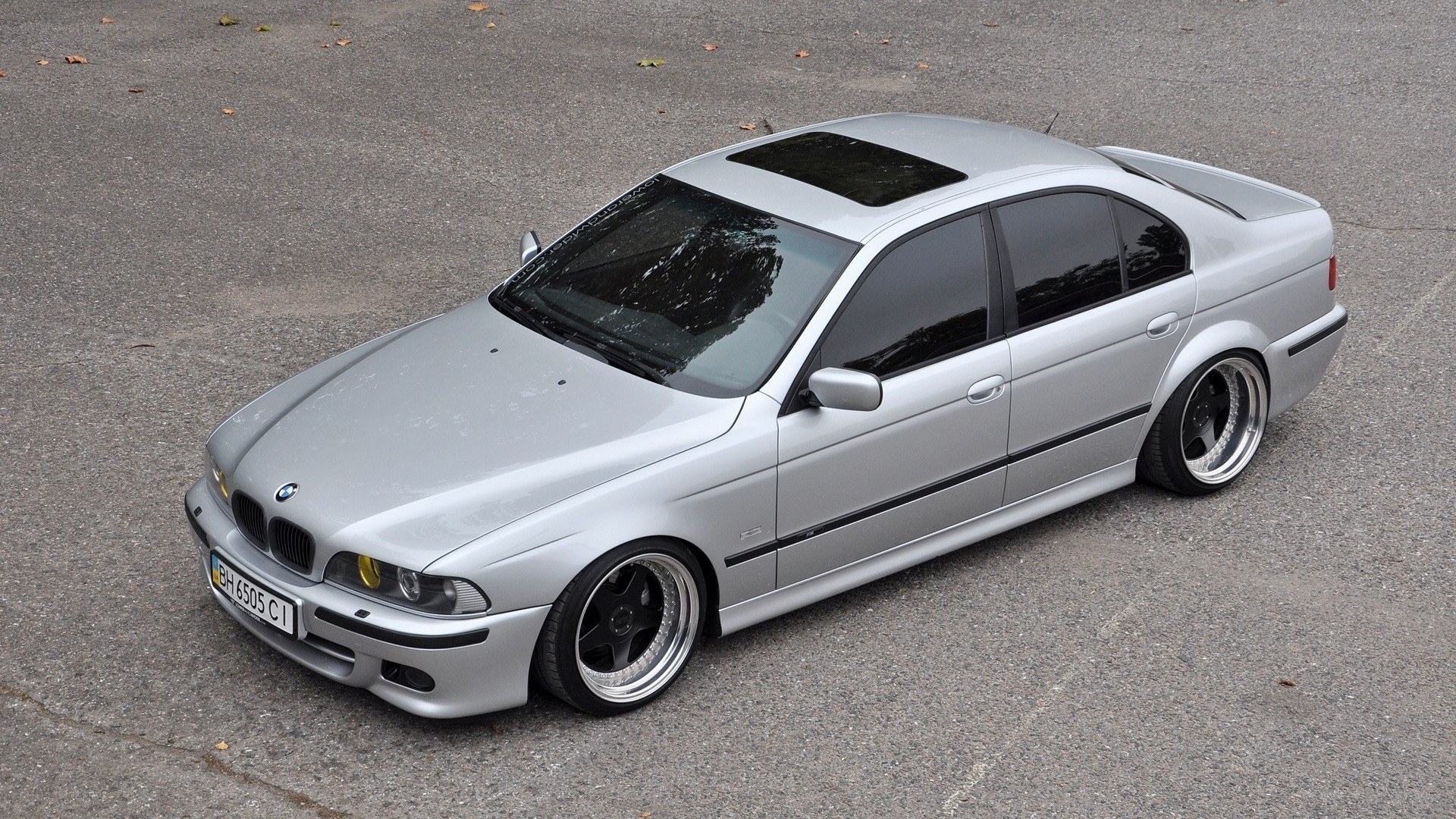 silver bmw sedan with custom wheels