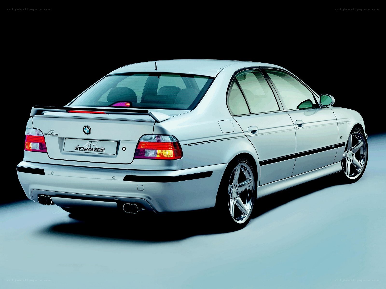 silver bmw sedan with spoiler