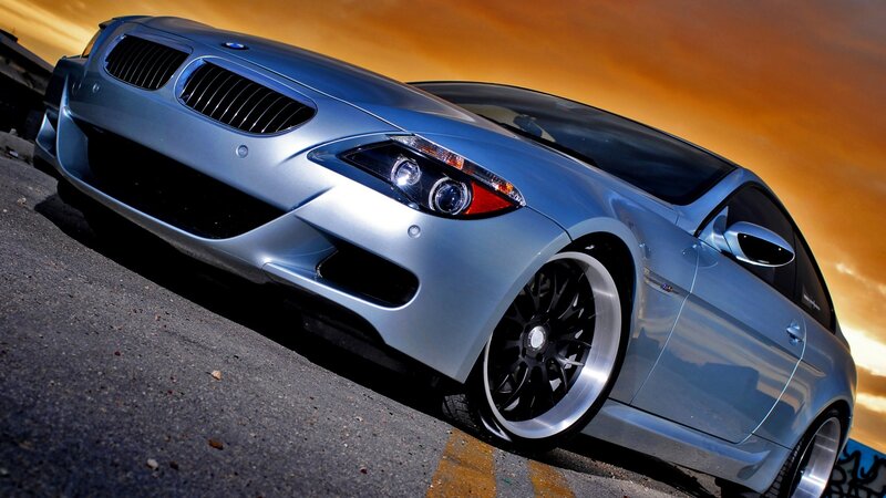silver BMW sports car at sunset
