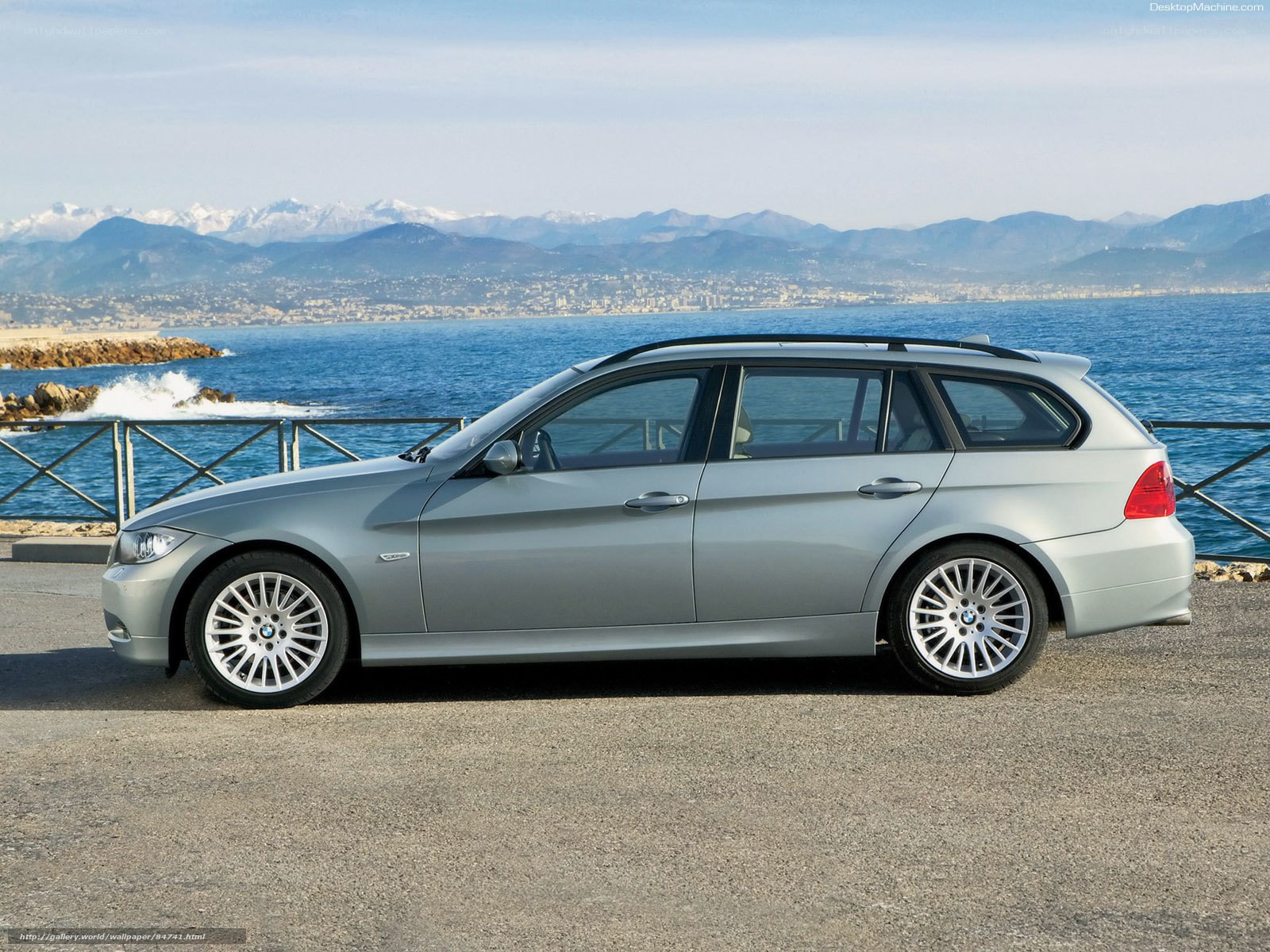 silver bmw station wagon by the sea