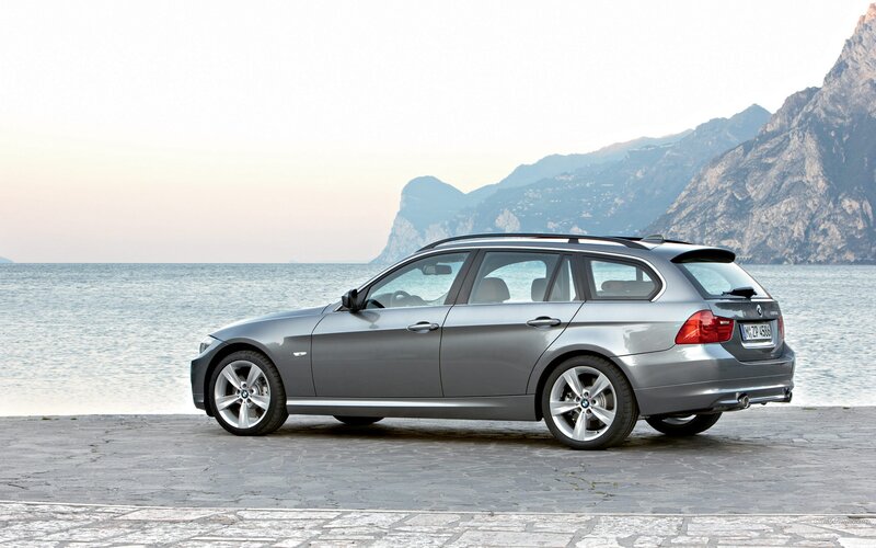 silver bmw station wagon by the sea