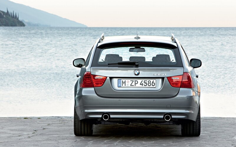 silver bmw station wagon by the sea
