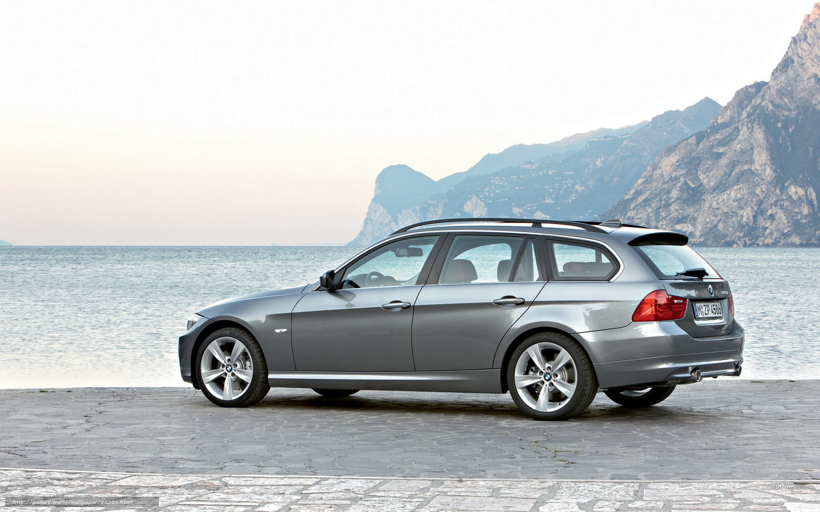 silver bmw station wagon by the sea
